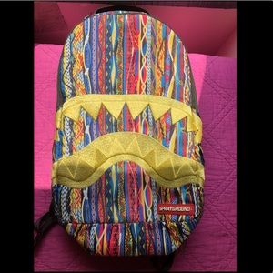Gold teeth shark spray ground book bag